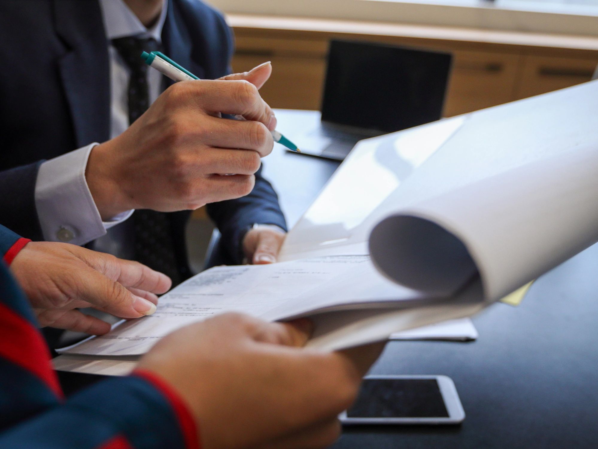 Professionals reviewing documents at desk